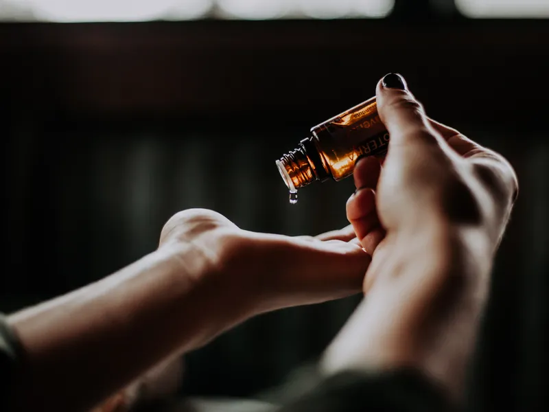 Image of oil being poured onto hand