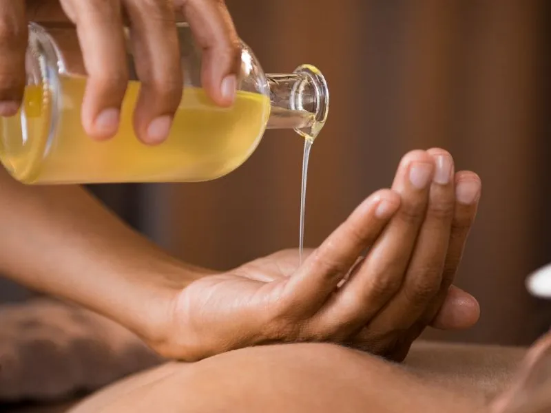 Image of oil being poured onto hand
